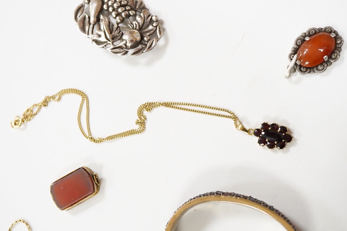 An 800 standard gilt white metal and garnet cluster set oval pendant, 18mm, on a 585 yellow metal fine link chain, 2.5 grams, a gilt white metal and garnet cluster set hinged bangle, two white metal brooches including on